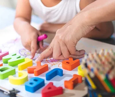 asian little girl is learning english letters